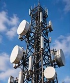 Telecommunications tower with antennas against a blue sky